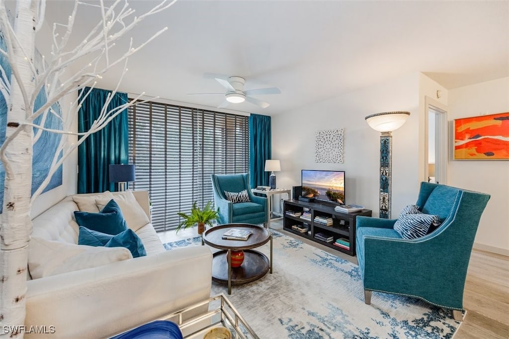 living room with ceiling fan and wood-type flooring