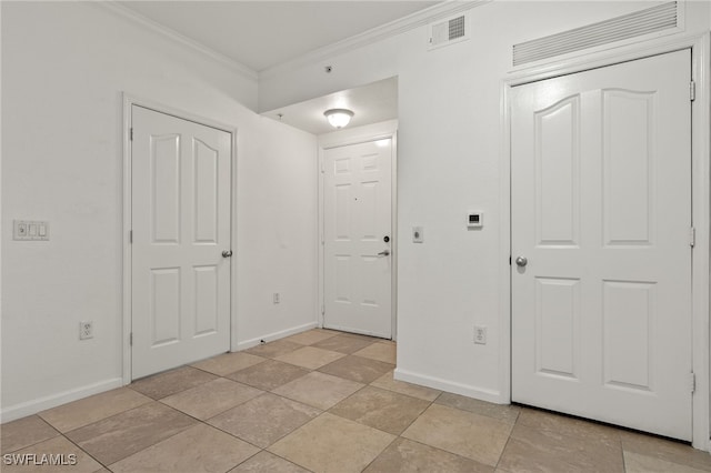 foyer entrance featuring crown molding