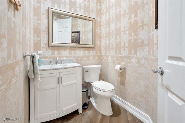 bathroom featuring hardwood / wood-style floors, vanity, and toilet