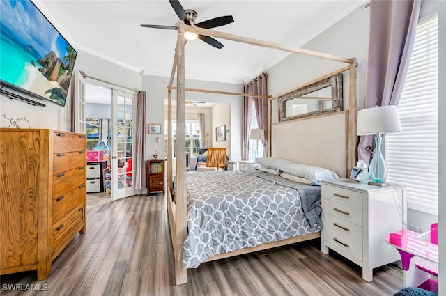 bedroom with ceiling fan, crown molding, hardwood / wood-style floors, and french doors