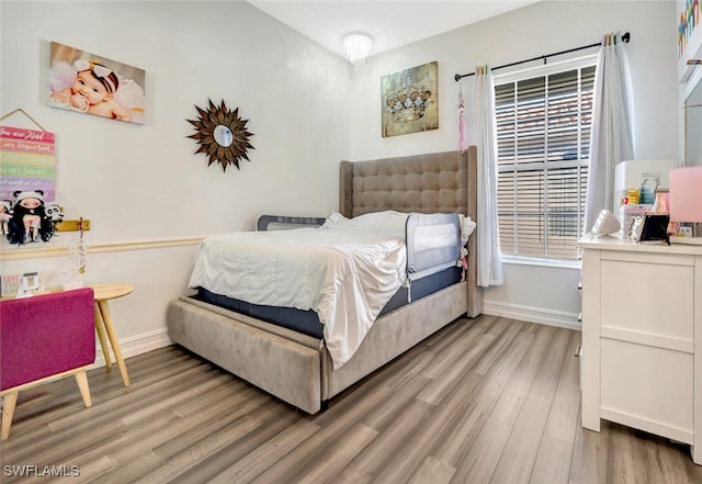 bedroom featuring multiple windows and wood-type flooring