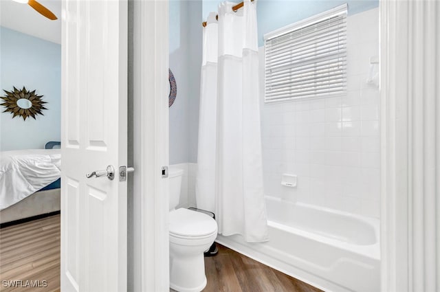 bathroom featuring hardwood / wood-style flooring, ceiling fan, toilet, and shower / tub combo