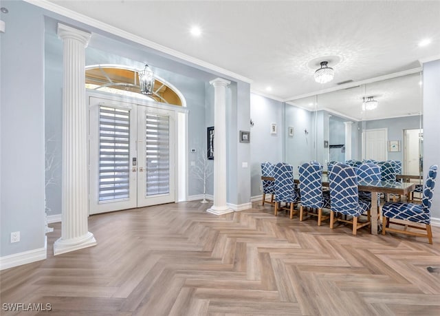 dining room featuring french doors, an inviting chandelier, light parquet floors, and crown molding