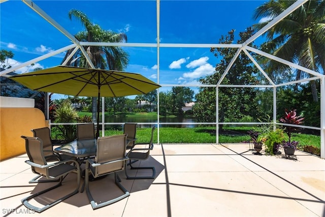 view of patio with a water view and a lanai