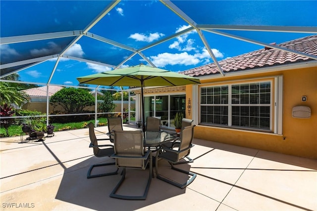 view of patio featuring a lanai and fence