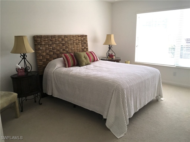 carpeted bedroom featuring baseboards