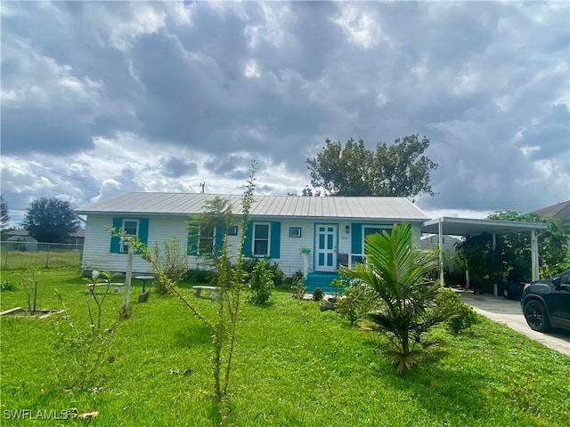 view of front facade with a front yard and a carport