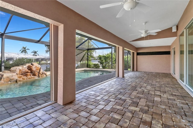 unfurnished sunroom featuring ceiling fan, a pool, and vaulted ceiling