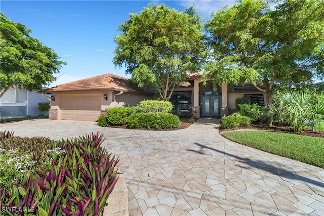 view of front of property featuring french doors and a garage