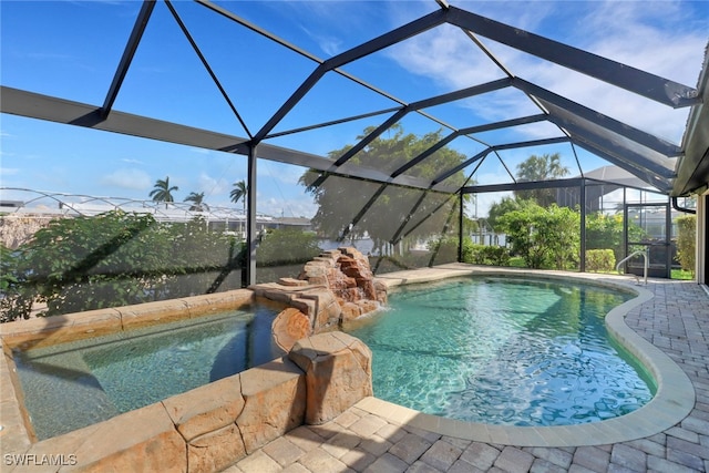 view of swimming pool with a patio and a lanai