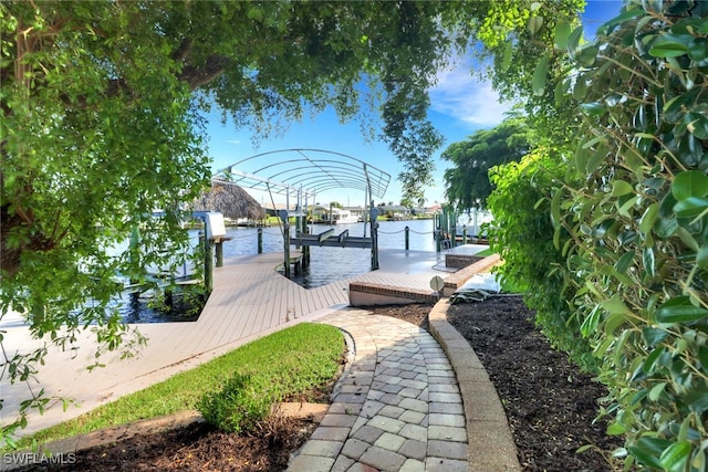 view of property's community featuring a water view and a boat dock