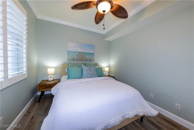 bedroom with ornamental molding, dark wood-type flooring, and ceiling fan