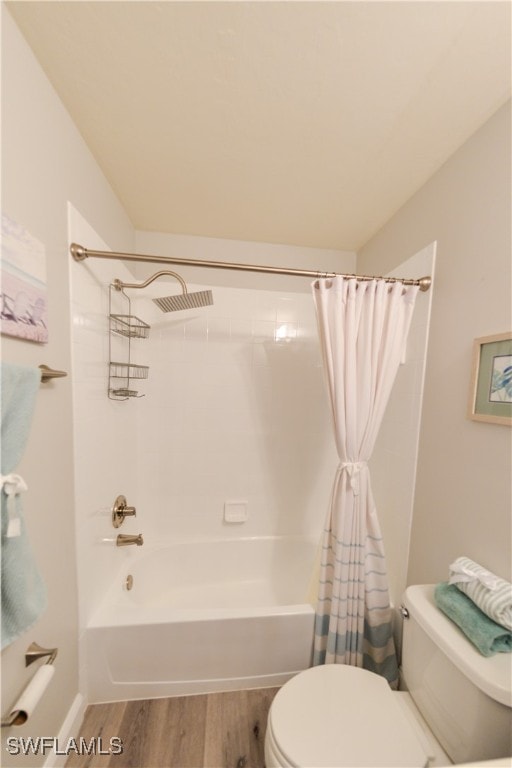 bathroom featuring toilet, hardwood / wood-style flooring, and shower / bath combination with curtain