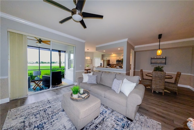 living room featuring crown molding, hardwood / wood-style floors, and ceiling fan