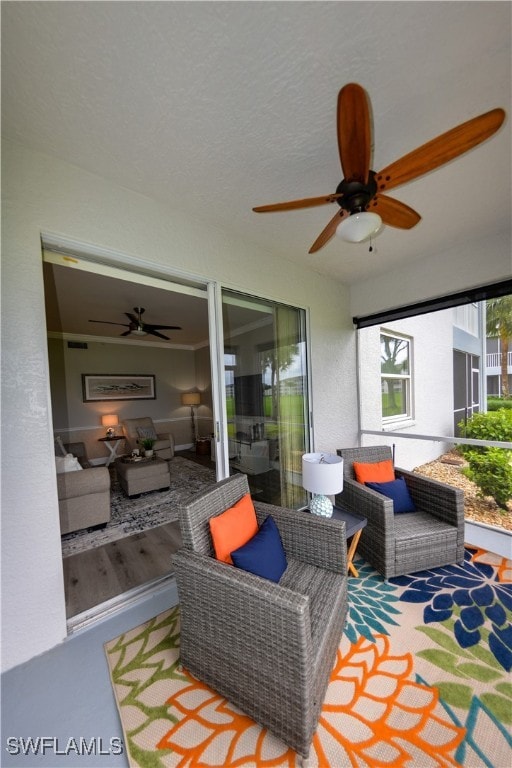 view of patio / terrace with ceiling fan and an outdoor living space