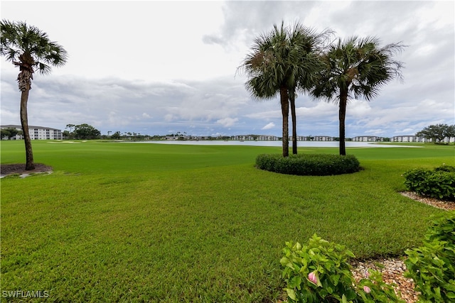 surrounding community featuring a yard and a water view