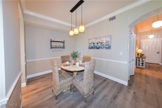 dining room featuring crown molding and hardwood / wood-style flooring