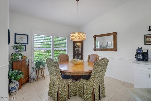 tiled dining room with vaulted ceiling