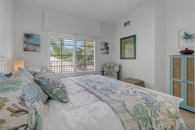 bedroom featuring carpet floors and lofted ceiling