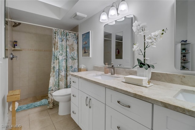 bathroom featuring tile patterned flooring, curtained shower, vanity, and toilet