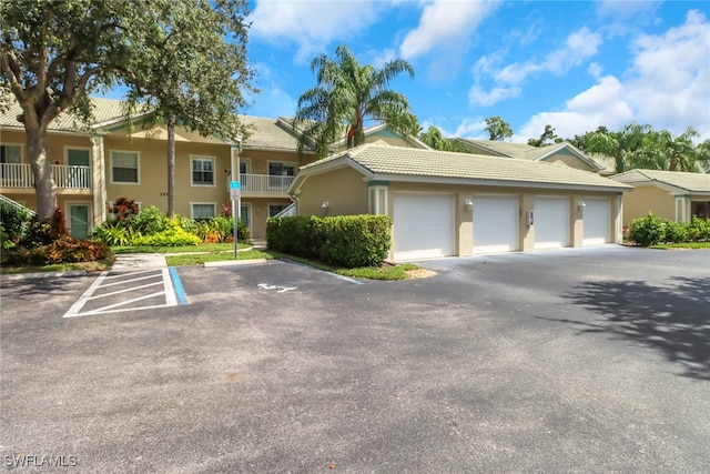 townhome / multi-family property with a balcony and a garage