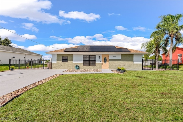 single story home featuring a front lawn and solar panels