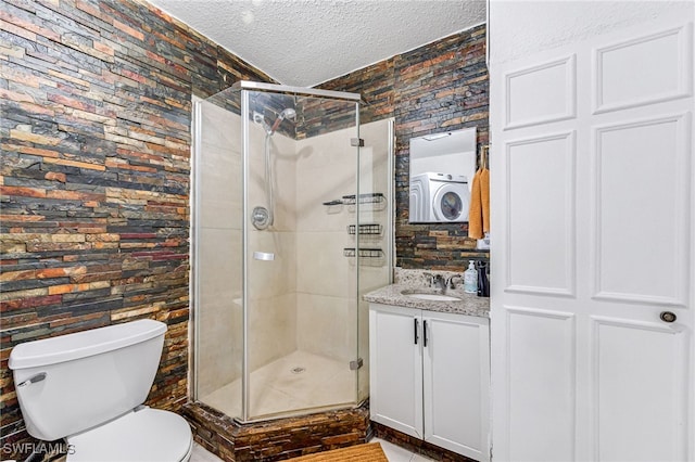 bathroom featuring vanity, walk in shower, toilet, and a textured ceiling