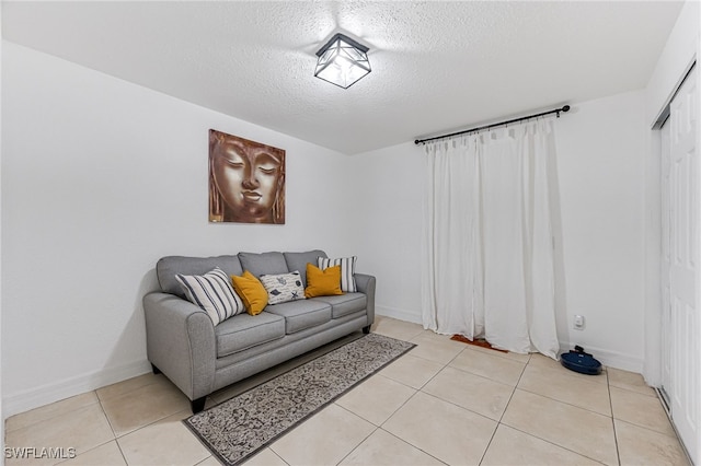 living room with light tile patterned floors and a textured ceiling