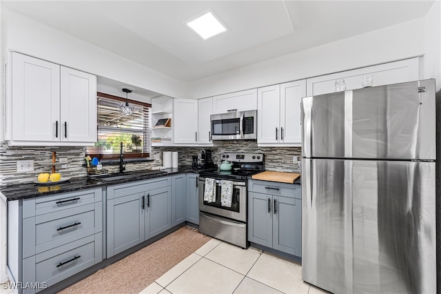 kitchen featuring light tile patterned flooring, gray cabinets, sink, white cabinets, and appliances with stainless steel finishes