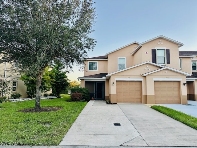 view of front property featuring a garage and a front lawn