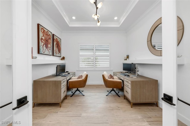 office with light hardwood / wood-style floors, a raised ceiling, and ornamental molding