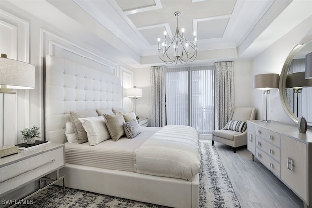 bedroom featuring crown molding, wood-type flooring, and a notable chandelier