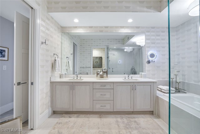 bathroom with vanity and independent shower and bath