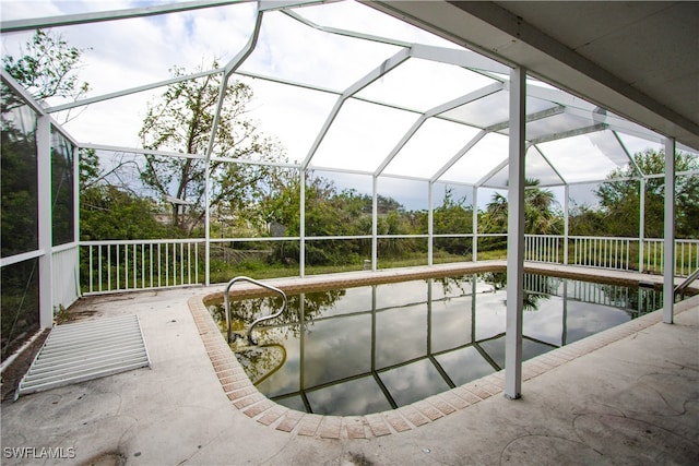 view of pool with a patio and a lanai