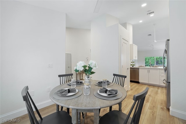 dining room with light wood-type flooring and sink