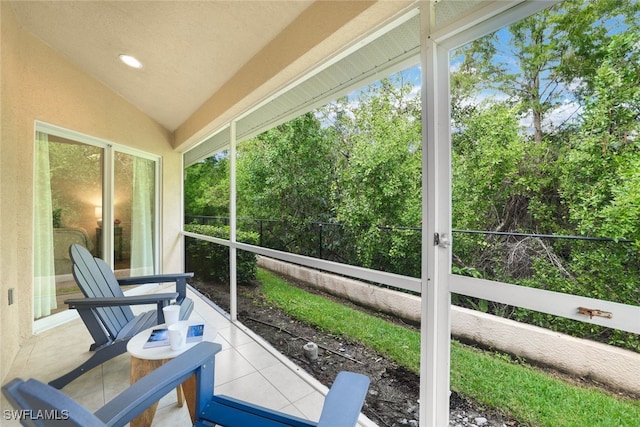 sunroom / solarium featuring lofted ceiling