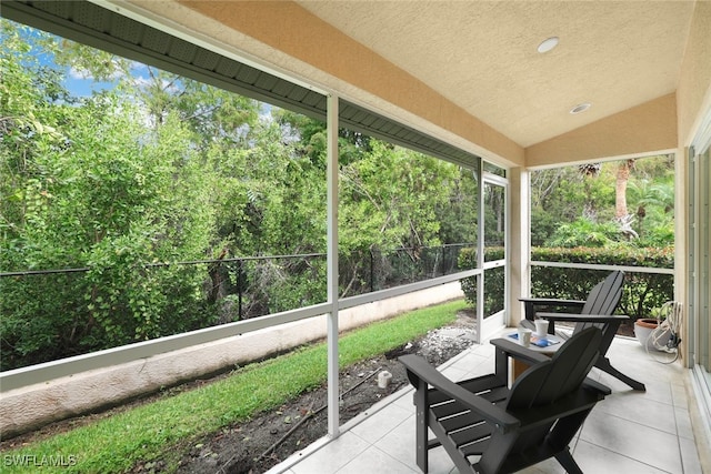 sunroom / solarium featuring vaulted ceiling