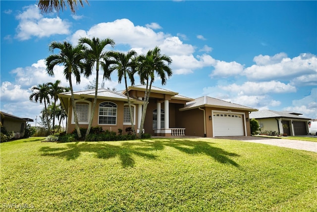 view of front of house featuring a front yard and a garage