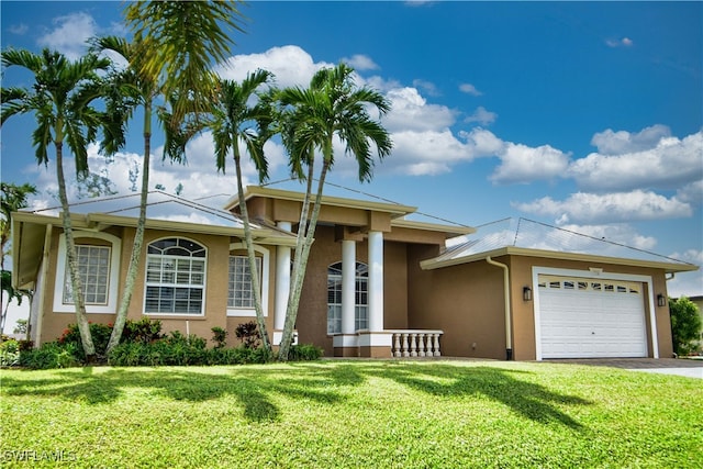 view of front of home with a garage and a front lawn