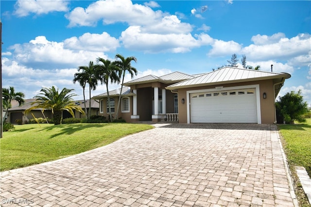 view of front of property featuring a garage and a front lawn