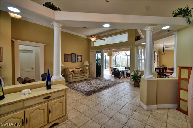 living room with light tile patterned flooring, crown molding, ceiling fan, and ornate columns