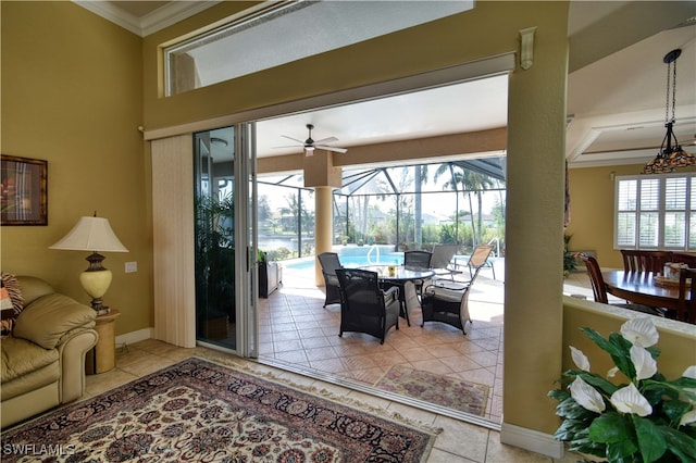 entryway with ornamental molding, plenty of natural light, and light tile patterned floors