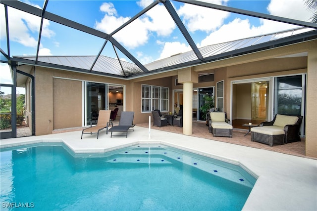 view of pool featuring an outdoor hangout area, glass enclosure, a patio area, and ceiling fan