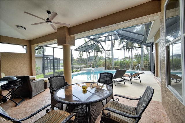 sunroom / solarium with vaulted ceiling, a wealth of natural light, and ceiling fan