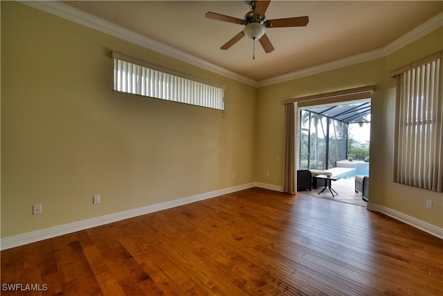 empty room with crown molding, ceiling fan, and wood-type flooring