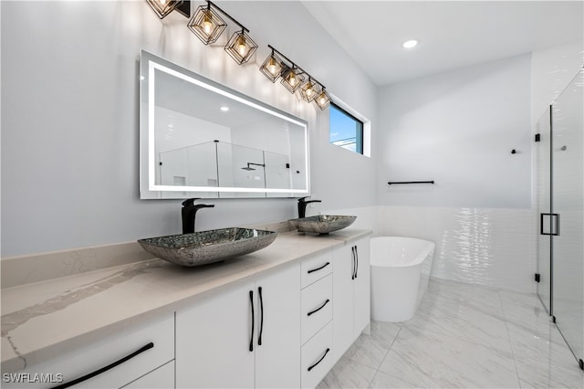 bathroom with vanity and separate shower and tub