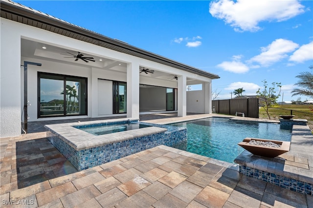 view of swimming pool with a patio, an in ground hot tub, and ceiling fan