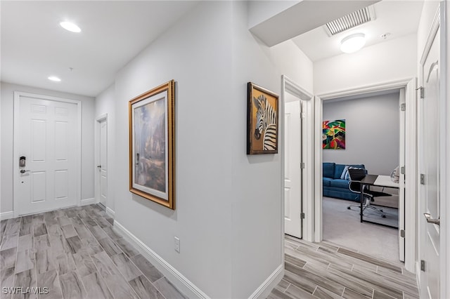 hall with light hardwood / wood-style flooring