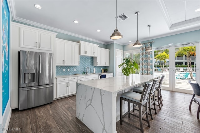 kitchen with dark wood-type flooring, french doors, stainless steel fridge with ice dispenser, and white cabinetry