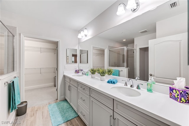 bathroom featuring vanity, a shower with shower door, and hardwood / wood-style flooring